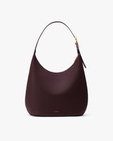 Curved bag with a single strap and curved top.