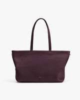 Tote bag with long handles shown against plain background