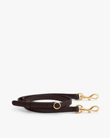 Leather strap with gold clasps and circular metal detail.