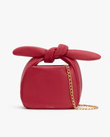 Handbag with a bow on top and a chain strap