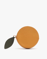 Round textured coin purse with leaf-shaped zipper pull.