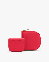 Two red textured pouches with zippers.