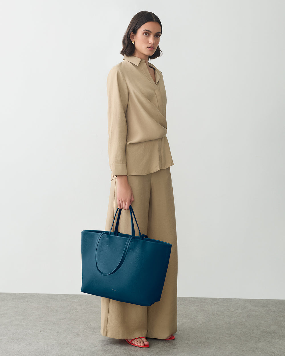 Classic Easy Tote Woman in matching outfit holding a large tote bag.