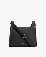 Handbag with shoulder strap and metal ring detail on front.