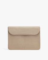 Laptop bag with flap front on a plain background