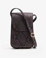 Textured pattern handbag with flap and shoulder strap.