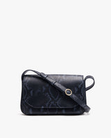 Small shoulder bag with a flap front and circular clasp
