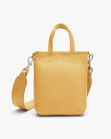 Handbag with top handles and a detachable shoulder strap.