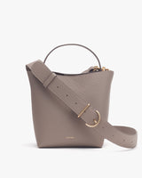 Handbag with short handle and long shoulder strap.