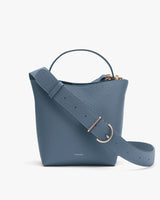 Handbag with a top handle and detachable shoulder strap.