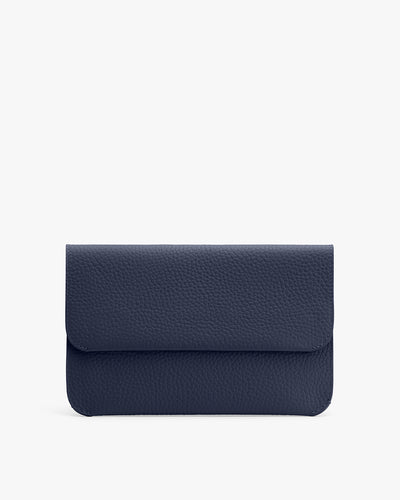 A textured clutch bag with a flap closure against a plain background.