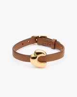 Leather bracelet with a gold clasp.