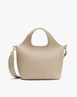 Handbag with rounded handles and adjustable shoulder strap