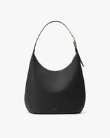 Minimalist handbag with a curved top and single strap.