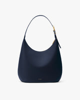 Shoulder bag with a sleek, curved design and a top handle.