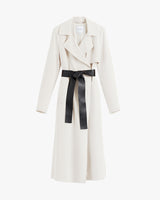 Trench coat with a wide belt tied in a bow.