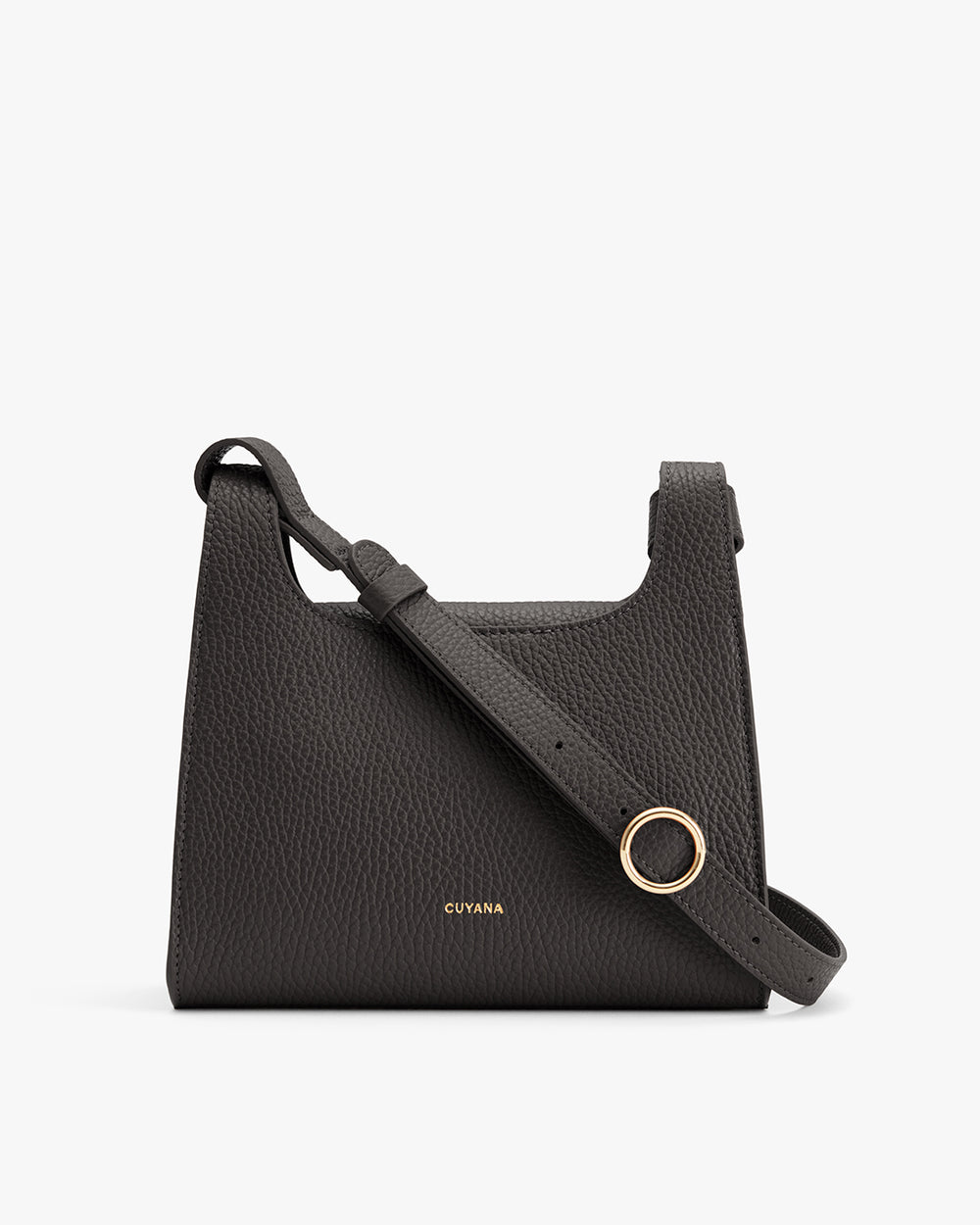 Handbag with a shoulder strap and a circular accent.