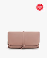 Closed clutch purse with a bow on the front and an award badge at the top.