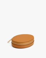 Round zippered case on a plain background.
