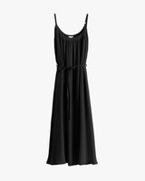 Sleeveless black long dress with tie on white background