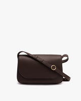 A shoulder bag with a flap and adjustable strap.