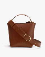 A structured handbag with a top handle and a wide shoulder strap.