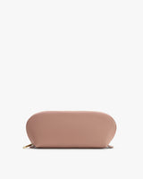 A rounded zipper pouch laying flat.