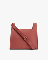Structured handbag with a thick strap and metal ring.