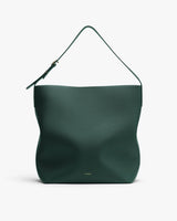 Minimalist hobo bag with a single strap and textured surface.