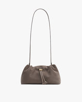 A small shoulder bag with a drawstring closure and long strap.