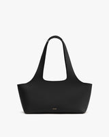 Handbag with wide straps and minimalist design.
