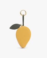 Keychain shaped like a fruit with a leaf and a loop on top.