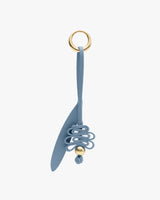 Keychain with a looped design and a decorative ball.