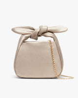 Handbag with a knotted handle and a chain strap.