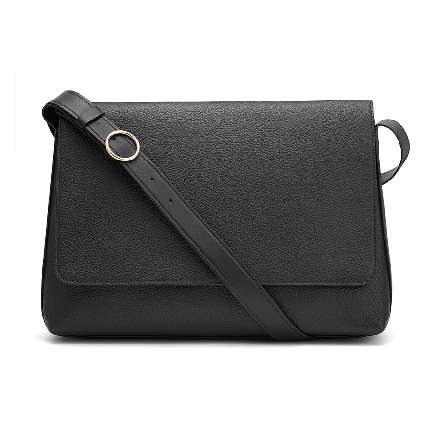 Crossbody bag with a flap and an adjustable strap.