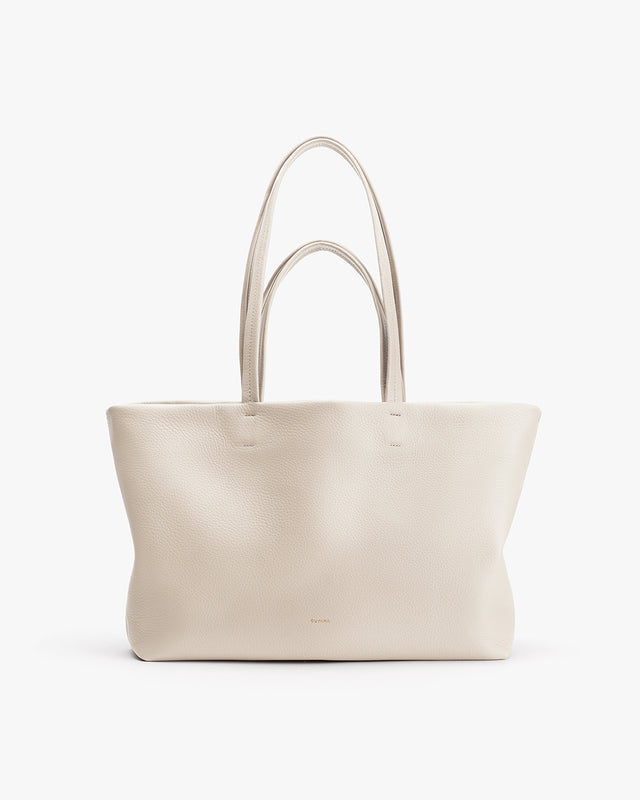 Large tote bag with two handles standing upright.