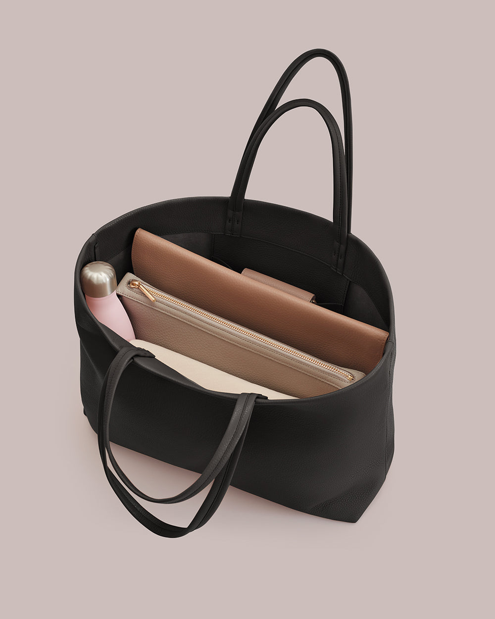 Open tote bag with a water bottle and two pouches inside