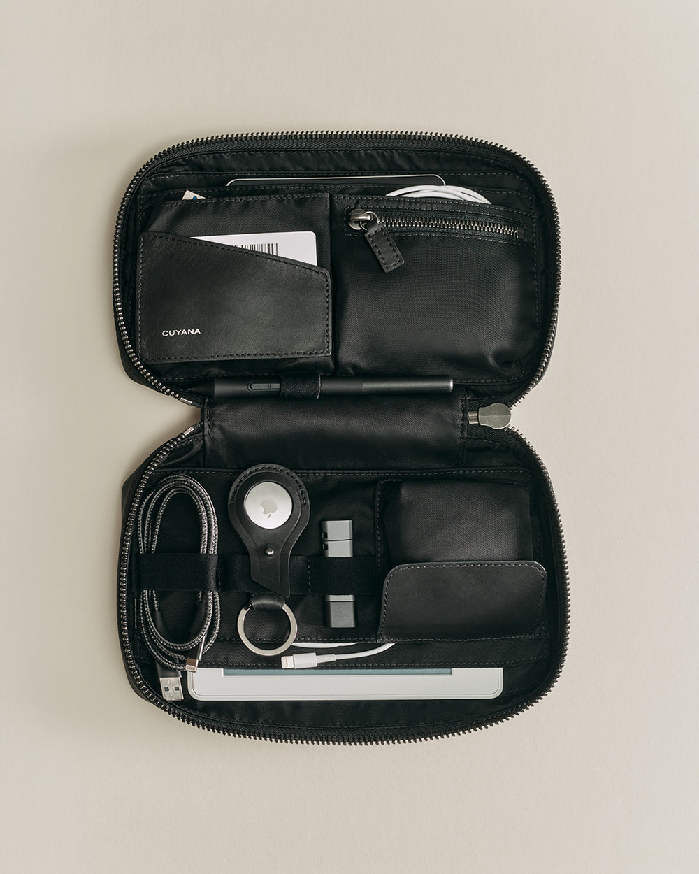 Small Tech Organizer Organizer case with various personal items and tech accessories.