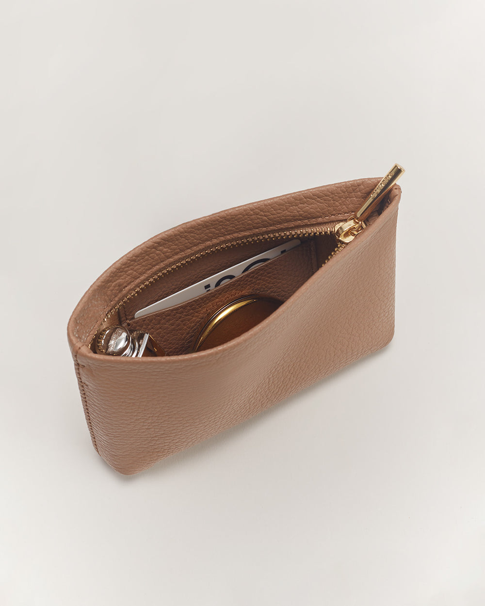 Sunglasses and keys inside an open zipper pouch.