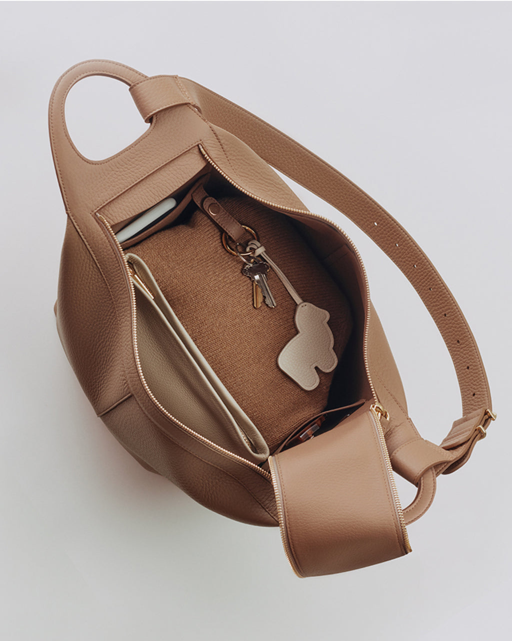 Open handbag showing contents including keys and wallet