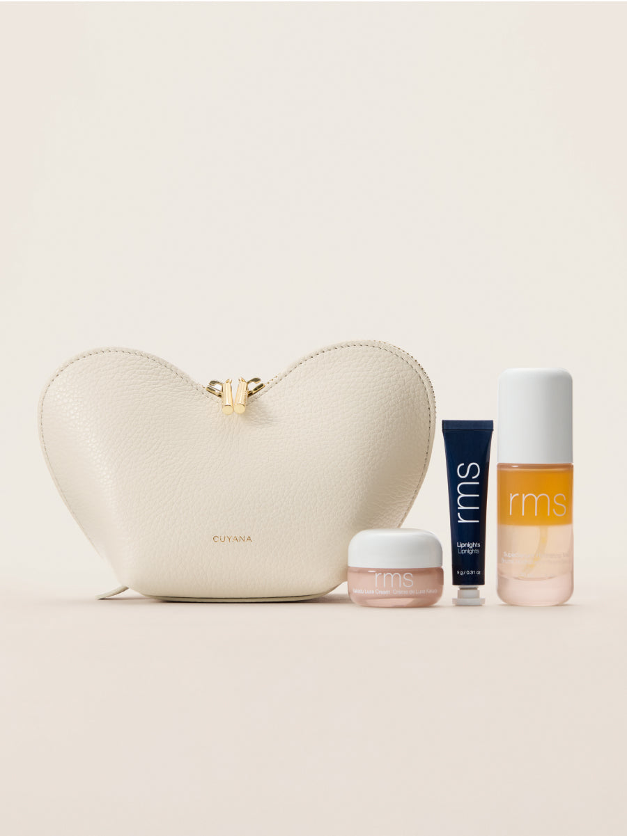 Heart-shaped pouch with three skincare products displayed in front.