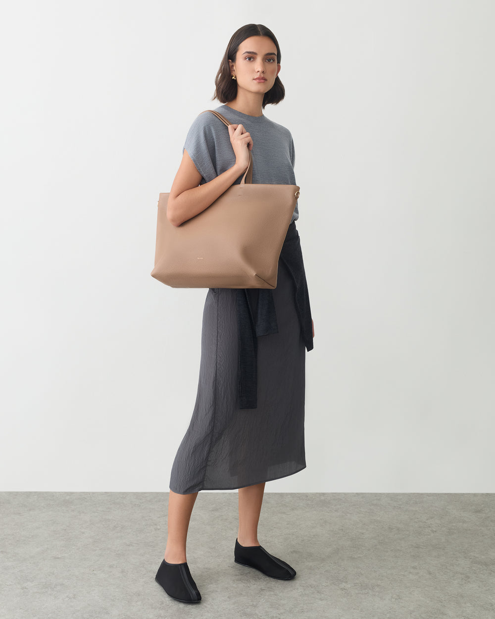 Classic Easy Zipper Tote Person standing with a large shoulder bag wearing a long dress and shoes.