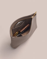 Open zipper pouch with cosmetic items inside.