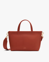 Handbag with two handles and a shoulder strap.