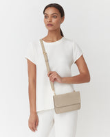 Woman standing with a shoulder bag