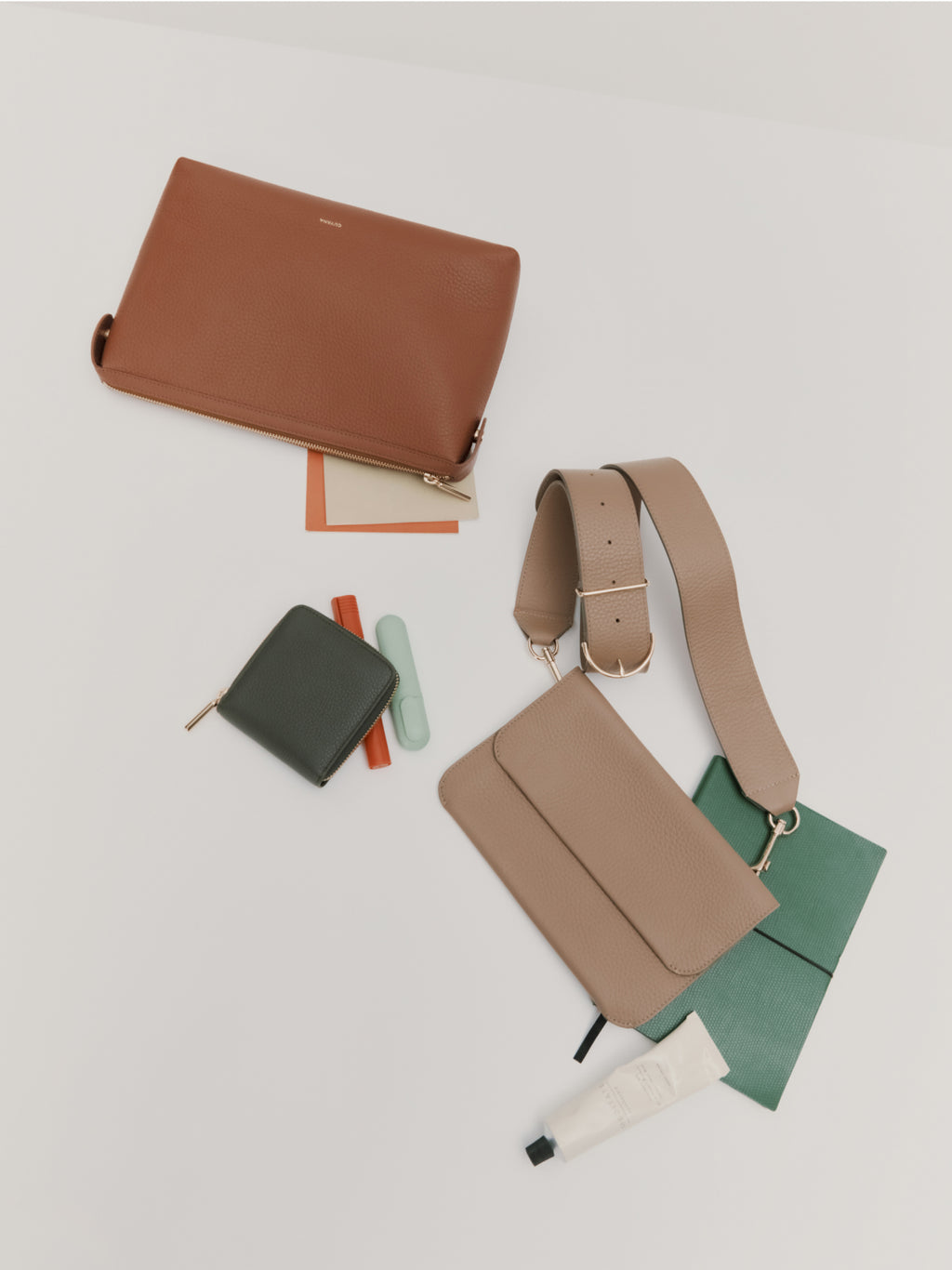 Assorted bags and small notebooks arranged on a surface.