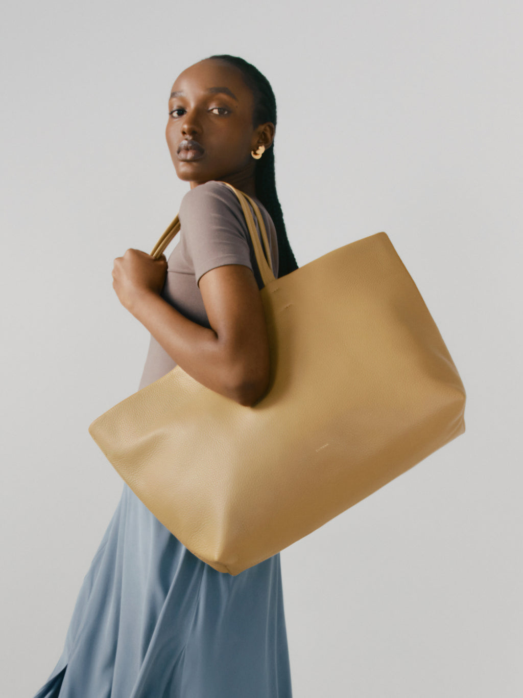Woman holding a large tote bag over her shoulder