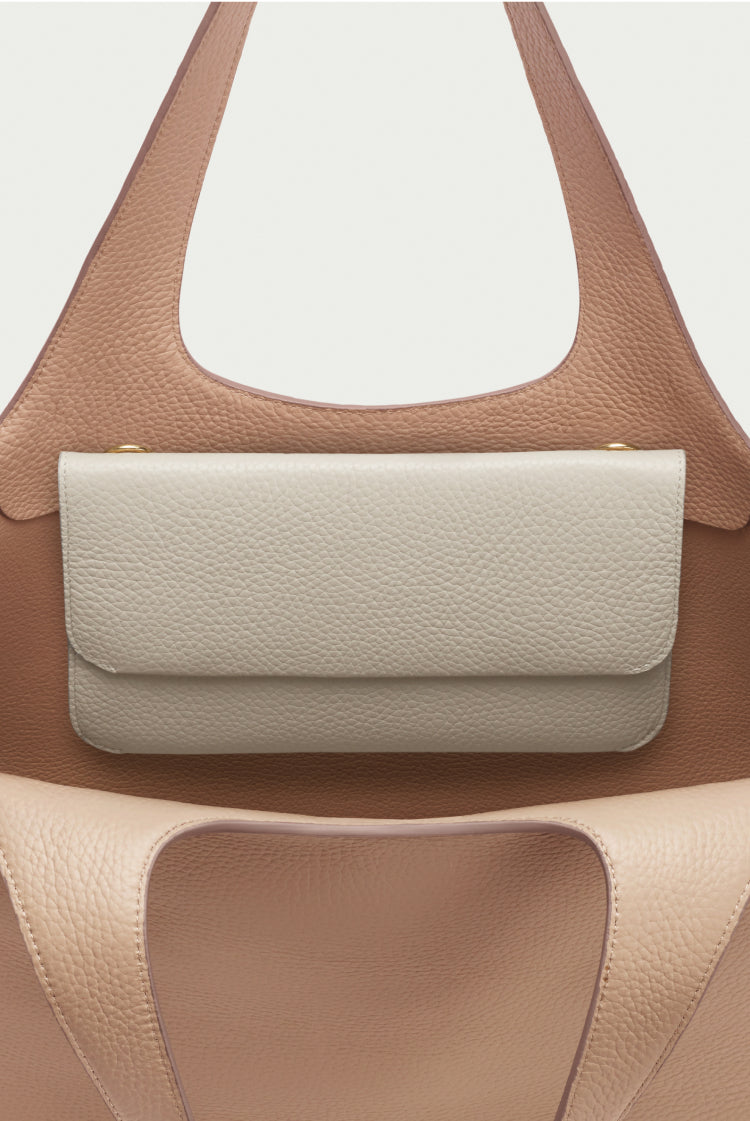 Handbag with a smaller purse attached to the front.