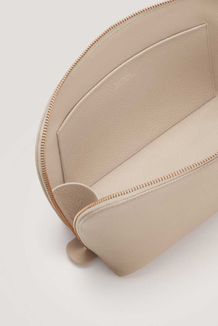 Top view of an open zipper pouch with internal compartments.