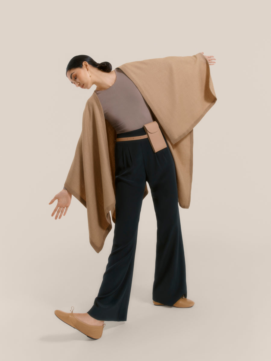 Woman posing dynamically in a fashionable outfit